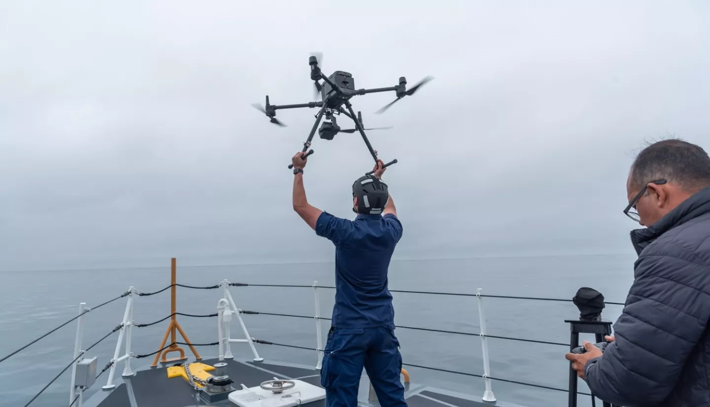 A crewmember of the Coast Guard cutter Blackfin releases a drone as part of Marine Oil Spill Thickness field campaign off the coast of Santa Barbara, CA. The drone carries a multi-spectral sensor to classify oil thickness. These data are compared with SAR imagery from NASA’s aircraft UAVSAR. Oscar Garcia (right) of the Watermapping LLC controls the drone. Credits: NASA/University of Maryland/Frank Monaldo