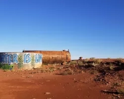 water tank in desert with "Water is Life" graffiti