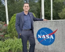 Photo of man (Ricardo Quiroga) with NASA logo