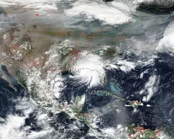 This image captured by the NOAA/NASA Suomi NPP satellite on Sep. 15, 2020 shows intense wildfires in the west (red dots) and smoke drifting across the country while several hurricanes formed – including Hurricane Sally as it stalled over Alabama (center). Credits: NASA Worldview, Earth Observing System Data and Information System