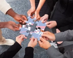 Photo of human hands holding a puzzle piece
