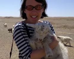 photo of woman holding goat in Mongolia