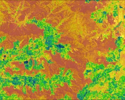 NDMI over a wildland urban interface in central Chile generated from Landsat 8 OLI median-reduced data from March 1, 2018 through February 28, 2022. Orange areas represent vegetated shrublands and forests with low moisture content and green areas representing vegetated agricultural areas with high moisture content. The NDMI was used as a proxy for wildfire fuel moisture in a wildfire risk assessment.