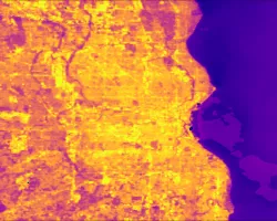 This image of Land Surface Temperature (LST) illustrates the urban heat island (UHI) effect that Milwaukee County experiences. Light orange areas represent hotter temperatures, which are concentrated in the high impervious areas of the city. Darker pinks represent cooler rural areas and underscore the temperature contrast across the landscape. The hotter areas of the city are historically redlined communities of color that disproportionately feel the effects of the UHI, including higher energy bills heat re