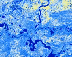 The satellite imagery is a Sentinel-1 Ground Range Detection C-SAR image from July 2nd, 2021, taken over the Sudd Wetland located in South Sudan. The image shows the 'VV' backscatter values, which correlate to vertical transmission and vertical reception from the C-SAR instrument and are used to classify wetland inundation extent. Low 'VV' values (blue) represent areas covered by open waters & inundated land areas and high 'VV' values (yellow) represent dry land areas.