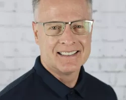 photo of man with glasses smiling