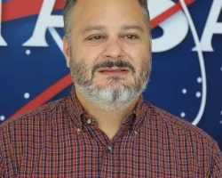 Image of David Barbato in front of the traditional NASA logo