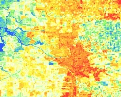 Summer 2013 - 2023 composite land surface temperature (LST) processed imagery from Landsat 8 TIRS showing Stockton, CA. Shades of dark blue, light blue, and green indicate lower temperatures, while yellow, orange, and red areas show hotter, less vegetated land. Areas with high LST are often significantly developed and prone to poor air quality because of transportation corridors, leading to interest from the community to provide solutions for cooling strategies.