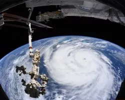 Hurricane Ida is pictured as a category two storm from the International Space Station as it orbited 263 miles above the Gulf of Mexico. At left, from top to bottom, are the Nauka multipurpose laboratory module, the Soyuz MS-18 crew ship and the Northrop Grumman Cygnus space freighter. Credits: NASA, International Space Station
