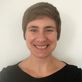 photo of white woman with short brown hair smiling at the camera