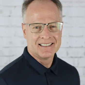 photo of man with glasses smiling