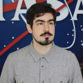 Carl pictured in front of the original NASA logo