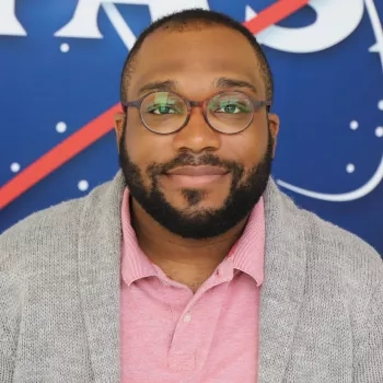 Selwyn pictured in front of the original NASA logo