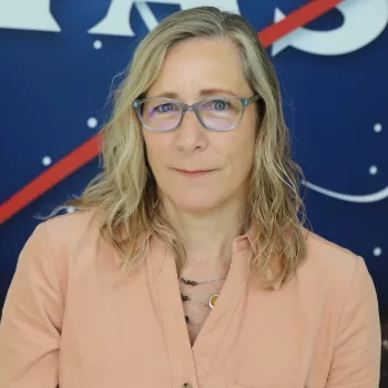 Sue pictured in front of the original NASA logo