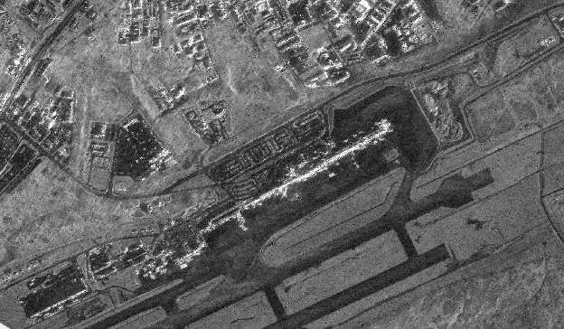 Black and white satellite image of an airport in Guam.