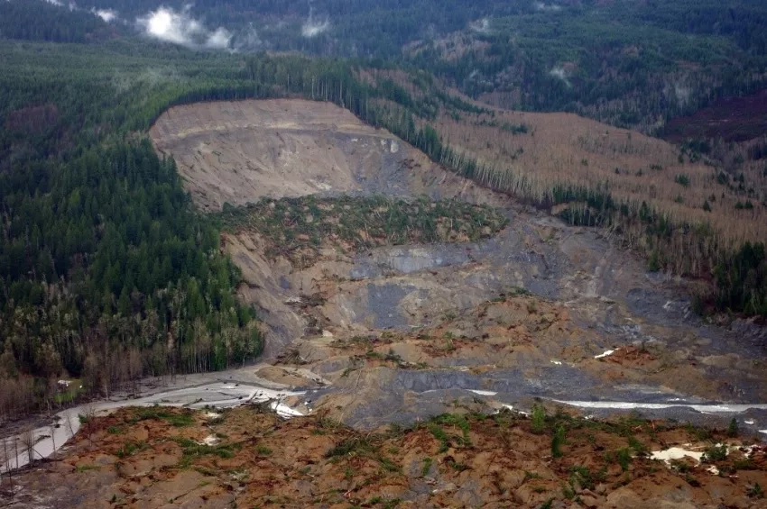 This photograph from an aerial survey shows the upper parts of the 2014 Oso landslide in northwest Washington. NASA’s landslide inventory documents events such as this one to improve model validation. Credits: Jonathan Godt, USGS